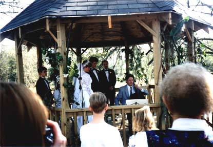 The shaded wooden gazebo serves as mini-stage  for the ceremony. Here cellist Harry Wimmer plays the gigantic C Major Bach Prelude for bride, groom and audience.